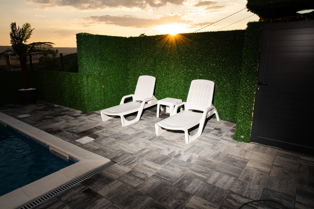 Sun loungers by the pool at sunset
